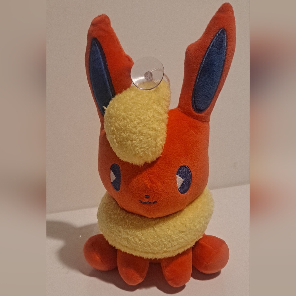 Flareon Poké Plush with a suction cup attached to.